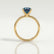 Lulu solitaire engagement ring in 18k yellow gold with an elongated cushion lab-grown alexandrite centre stone, side profile showing the setting and band.