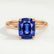 Lulu solitaire engagement ring in 18k rose gold with an elongated cushion blue lab-grown sapphire centre stone, front view.
