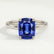 Lulu solitaire engagement ring in 18k white gold with an elongated cushion blue lab-grown sapphire centre stone, front view.