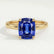 Lulu solitaire engagement ring in 18k yellow gold with an elongated cushion blue lab-grown sapphire centre stone, front view.