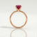Lulu solitaire engagement ring in 18k rose gold with an elongated cushion lab-grown ruby centre stone, side profile showing the setting and band.