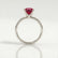 Lulu solitaire engagement ring in 18k white gold with an elongated cushion lab-grown ruby centre stone, side profile showing the setting and band.