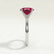 Lulu solitaire engagement ring in platinum with an elongated cushion lab-grown ruby centre stone, end-on view showing the setting and band.