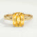 Lulu solitaire engagement ring in 18k yellow gold with an elongated cushion yellow lab-grown sapphire centre stone, front view.