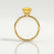 Lulu solitaire engagement ring in 18k yellow gold with an elongated cushion yellow lab-grown sapphire centre stone, side profile showing the setting and band.