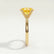 Lulu solitaire engagement ring in 18k yellow gold with an elongated cushion yellow lab-grown sapphire centre stone, end-on view showing the setting and band.