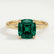 Lulu solitaire engagement ring in 18k yellow gold with a cushion lab-grown emerald centre stone, front view.