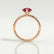 Lulu solitaire engagement ring in 18k rose gold with a marquise lab-grown ruby centre stone, side profile showing the setting and band.