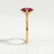Lulu solitaire engagement ring in 18k yellow gold with a marquise lab-grown ruby centre stone, end-on view showing the setting and band.