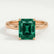 Lulu solitaire engagement ring in 18k rose gold with a radiant lab-grown emerald centre stone, front view.