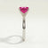 Lulu solitaire engagement ring with a radiant pink lab-grown sapphire centre stone, end-on view showing the setting and band.