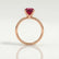 Lulu solitaire engagement ring in 18k rose gold with a radiant lab-grown ruby centre stone, side profile showing the setting and band.