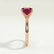 Lulu solitaire engagement ring in 18k rose gold with a radiant lab-grown ruby centre stone, end-on view showing the setting and band.