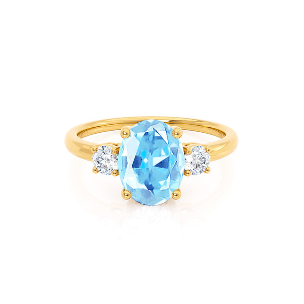 LOUELLA - Chatham® Oval Aqua Spinel Oval Petite Trilogy Engagement Ring 18k Yellow Gold