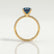 Macy shoulder-set engagement ring in 18k yellow gold with a round lab-grown alexandrite centre stone, side profile showing the setting and band.