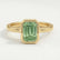 Front view of a green emerald-cut lab-grown diamond engagement ring in a 18k yellow gold bezel setting