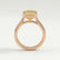 Side view of a yellow emerald-cut lab-grown diamond engagement ring in a 18k rose gold bezel setting