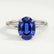 Paris hidden halo engagement ring in 18k white gold with an oval blue lab-grown sapphire centre stone and diamond accents, front view.