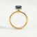 Paris hidden halo engagement ring in 18k yellow gold with an elongated cushion lab-grown alexandrite centre stone and diamond accents, side profile showing the setting and band.