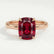 Paris hidden halo engagement ring in 18k rose gold with an elongated cushion lab-grown ruby centre stone and diamond accents, front view.