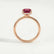 Paris hidden halo engagement ring in 18k rose gold with a radiant lab-grown ruby centre stone and diamond accents, side profile showing the setting and band.