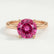 Paris hidden halo engagement ring in 18k rose gold with a round pink lab-grown sapphire centre stone and diamond accents, front view.
