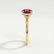 Paris hidden halo engagement ring in 18k yellow gold with a round lab-grown ruby centre stone and diamond accents, end-on view showing the setting and band.
