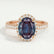 Rosa halo engagement ring in 18k rose gold with an oval lab-grown alexandrite centre stone and diamond accents, front view.