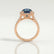 Rosa halo engagement ring in 18k rose gold with an oval lab-grown alexandrite centre stone and diamond accents, side profile showing the setting and band.