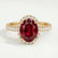 Rosa halo engagement ring in 18k yellow gold with an oval lab-grown ruby centre stone and diamond accents, front view.