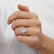 Oval gemstone engagement ring, worn on a model's hand.