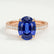 Viola shoulder-set engagement ring in 18k rose gold with an oval blue lab-grown sapphire centre stone and diamond accents, front view.