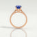 Viola shoulder-set engagement ring in 18k rose gold with an oval blue lab-grown sapphire centre stone and diamond accents, side profile showing the setting and band.
