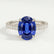 Viola shoulder-set engagement ring in platinum with an oval blue lab-grown sapphire centre stone and diamond accents, front view.