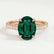 Viola shoulder-set engagement ring in 18k rose gold with an oval lab-grown emerald centre stone and diamond accents, front view.