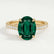 Viola shoulder-set engagement ring in 18k yellow gold with an oval lab-grown emerald centre stone and diamond accents, front view.