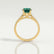Viola shoulder-set engagement ring in 18k yellow gold with an oval lab-grown emerald centre stone and diamond accents, side profile showing the setting and band.