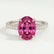 Viola shoulder-set engagement ring in platinum with an oval pink lab-grown sapphire centre stone and diamond accents, front view.