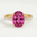 Viola shoulder-set engagement ring in 18k yellow gold with an oval pink lab-grown sapphire centre stone and diamond accents, front view.