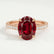 Viola shoulder-set engagement ring in 18k rose gold with an oval lab-grown ruby centre stone and diamond accents, front view.