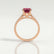 Viola shoulder-set engagement ring in 18k rose gold with an oval lab-grown ruby centre stone and diamond accents, side profile showing the setting and band.