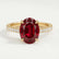 Viola shoulder-set engagement ring in 18k yellow gold with an oval lab-grown ruby centre stone and diamond accents, front view.