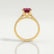 Viola shoulder-set engagement ring in 18k yellow gold with an oval lab-grown ruby centre stone and diamond accents, side profile showing the setting and band.