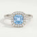 Violette halo engagement ring with a cushion aquamarine-blue lab-grown sapphire centre stone and diamond accents, front view.