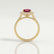 Violette halo engagement ring in 18k yellow gold with a cushion lab-grown ruby centre stone and diamond accents, side profile showing the setting and band.