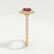 Violette halo engagement ring in 18k yellow gold with a cushion lab-grown ruby centre stone and diamond accents, end-on view showing the setting and band.