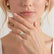 Video showing the Lavender petite halo engagement ring in 18k yellow gold with a round natural diamond centre stone worn on a model's hand.