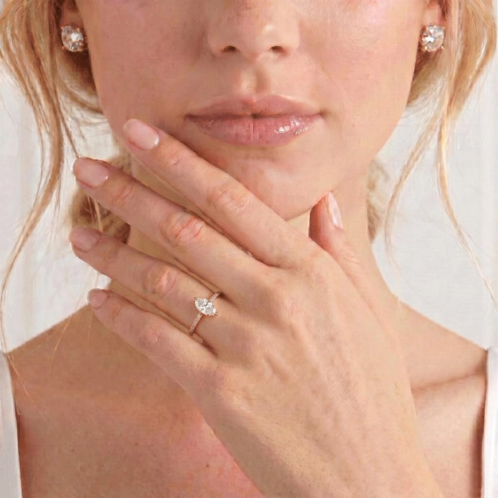 Video showing the Macy petite shoulder-set engagement ring with a marquise moissanite centre stone and diamond accents worn on a model's hand.