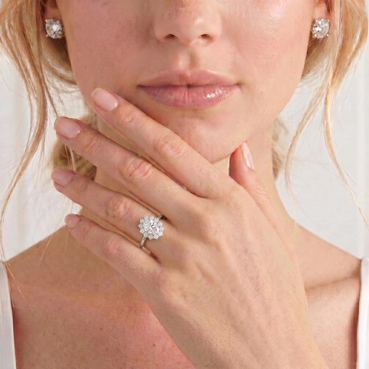 Video showing the Diana halo engagement ring with an oval moissanite centre stone and diamond accents worn on a model's hand.