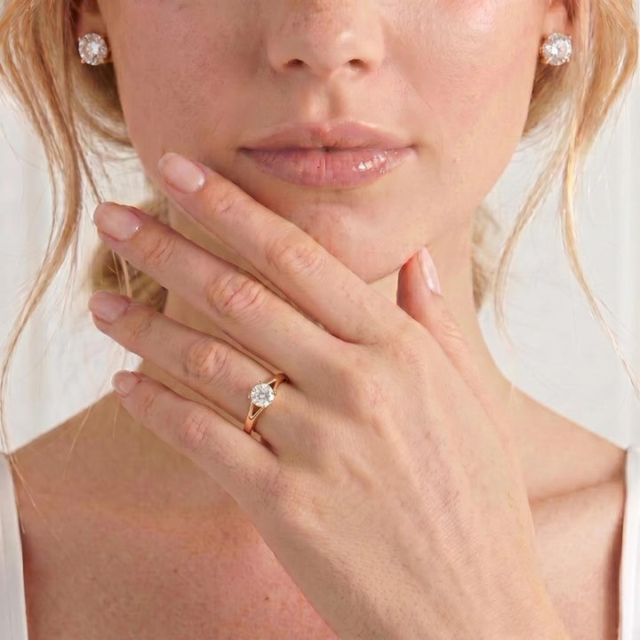 Video showing a round gemstone engagement ring worn on a model's hand.